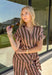 Warm neutral stripes make this Entro top an easy addition to your fall lineup. The button-front design gives it a classic feel, while the self-tie waist adds shape and a playful finishing touch. Short sleeves keep it lightweight enough for those warmer autumn days, making it an easy option for work, lunch plans, or a weekend out. Pair it with the matching pants for a coordinated two-piece set that does all the styling for you, or wear it individually with denim or solid bottoms for even more outfit options.