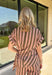 Warm neutral stripes make this Entro top an easy addition to your fall lineup. The button-front design gives it a classic feel, while the self-tie waist adds shape and a playful finishing touch. Short sleeves keep it lightweight enough for those warmer autumn days, making it an easy option for work, lunch plans, or a weekend out. Pair it with the matching pants for a coordinated two-piece set that does all the styling for you, or wear it individually with denim or solid bottoms for even more outfit options.