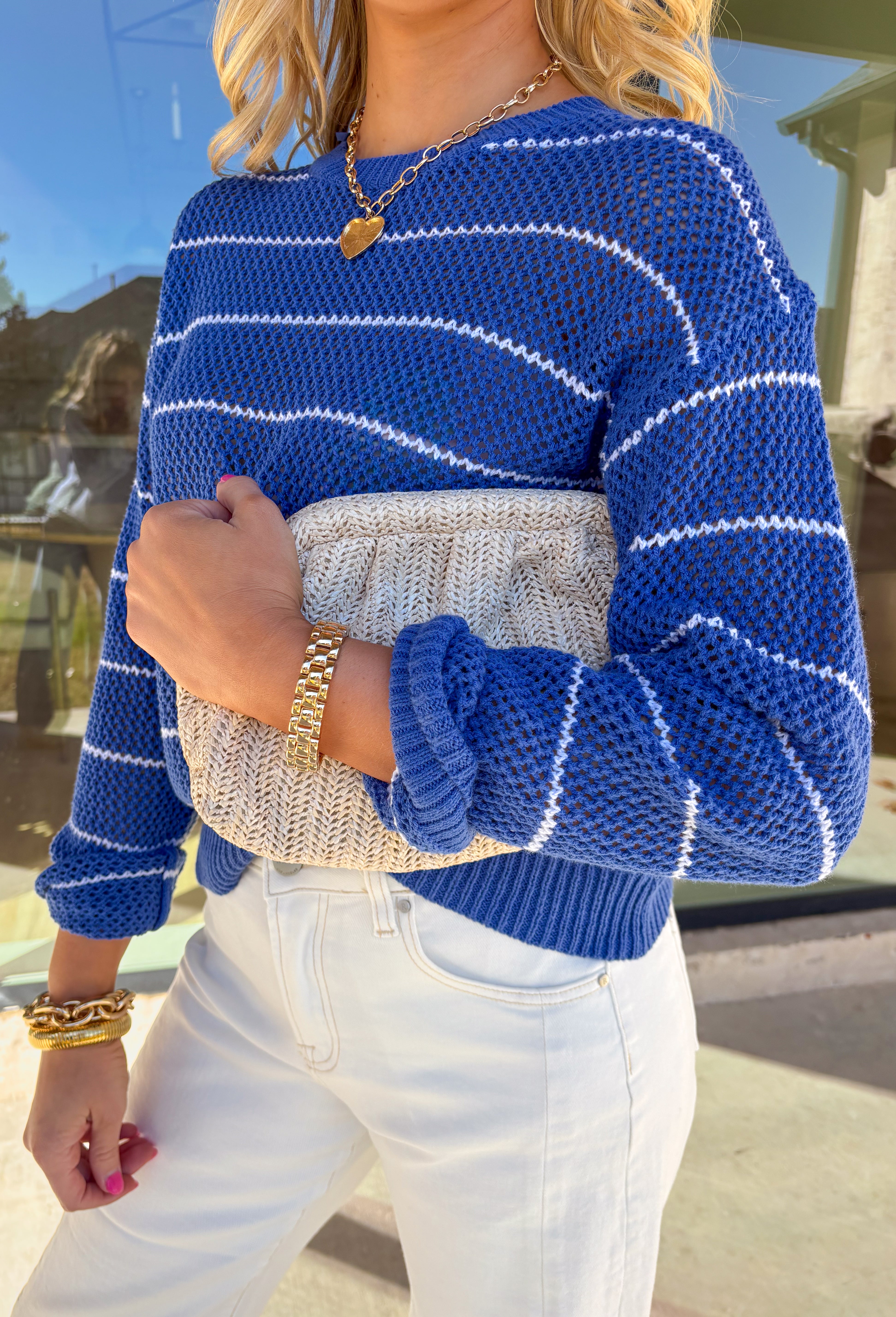 Lightweight, breezy, and perfect for spring layering, this blue and white striped open knit sweater by Wishlist is an easy warm-weather staple. The open knit design keeps it airy and relaxed, making it perfect for tossing on over a tank or bralette on sunny days. With timeless stripes and a soft knit feel, this sweater gives effortless coastal vibes—whether you’re headed to brunch, the beach, or just want something cute and comfy for everyday.