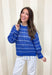 Lightweight, breezy, and perfect for spring layering, this blue and white striped open knit sweater by Wishlist is an easy warm-weather staple. The open knit design keeps it airy and relaxed, making it perfect for tossing on over a tank or bralette on sunny days. With timeless stripes and a soft knit feel, this sweater gives effortless coastal vibes—whether you’re headed to brunch, the beach, or just want something cute and comfy for everyday.