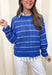 Lightweight, breezy, and perfect for spring layering, this blue and white striped open knit sweater by Wishlist is an easy warm-weather staple. The open knit design keeps it airy and relaxed, making it perfect for tossing on over a tank or bralette on sunny days. With timeless stripes and a soft knit feel, this sweater gives effortless coastal vibes—whether you’re headed to brunch, the beach, or just want something cute and comfy for everyday.