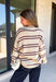 Nothing says cozy season quite like a classic striped sweater! This soft neutral knit is accented with timeless navy and burgundy stripes, creating the perfect color combination for fall. Exposed hems give it a relaxed, lived-in feel, while the ribbed neckline, cuffs, and hem add a polished finish. Whether you're headed to a football game, a weekend getaway, or simply enjoying a crisp autumn day, this cozy sweater is one you'll love reaching for.