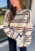 Nothing says cozy season quite like a classic striped sweater! This soft neutral knit is accented with timeless navy and burgundy stripes, creating the perfect color combination for fall. Exposed hems give it a relaxed, lived-in feel, while the ribbed neckline, cuffs, and hem add a polished finish. Whether you're headed to a football game, a weekend getaway, or simply enjoying a crisp autumn day, this cozy sweater is one you'll love reaching for.