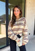 Nothing says cozy season quite like a classic striped sweater! This soft neutral knit is accented with timeless navy and burgundy stripes, creating the perfect color combination for fall. Exposed hems give it a relaxed, lived-in feel, while the ribbed neckline, cuffs, and hem add a polished finish. Whether you're headed to a football game, a weekend getaway, or simply enjoying a crisp autumn day, this cozy sweater is one you'll love reaching for.