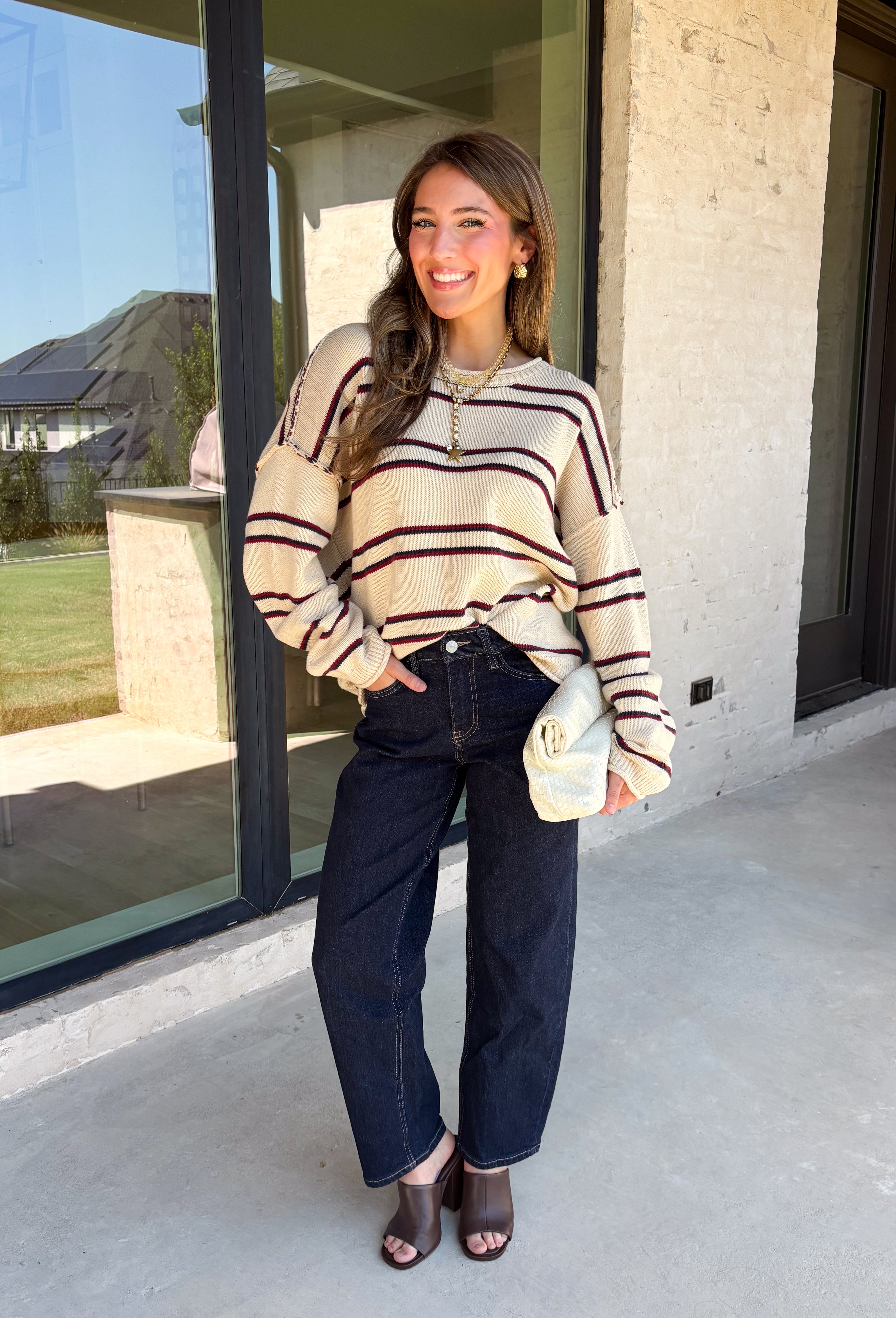 Nothing says cozy season quite like a classic striped sweater! This soft neutral knit is accented with timeless navy and burgundy stripes, creating the perfect color combination for fall. Exposed hems give it a relaxed, lived-in feel, while the ribbed neckline, cuffs, and hem add a polished finish. Whether you're headed to a football game, a weekend getaway, or simply enjoying a crisp autumn day, this cozy sweater is one you'll love reaching for.