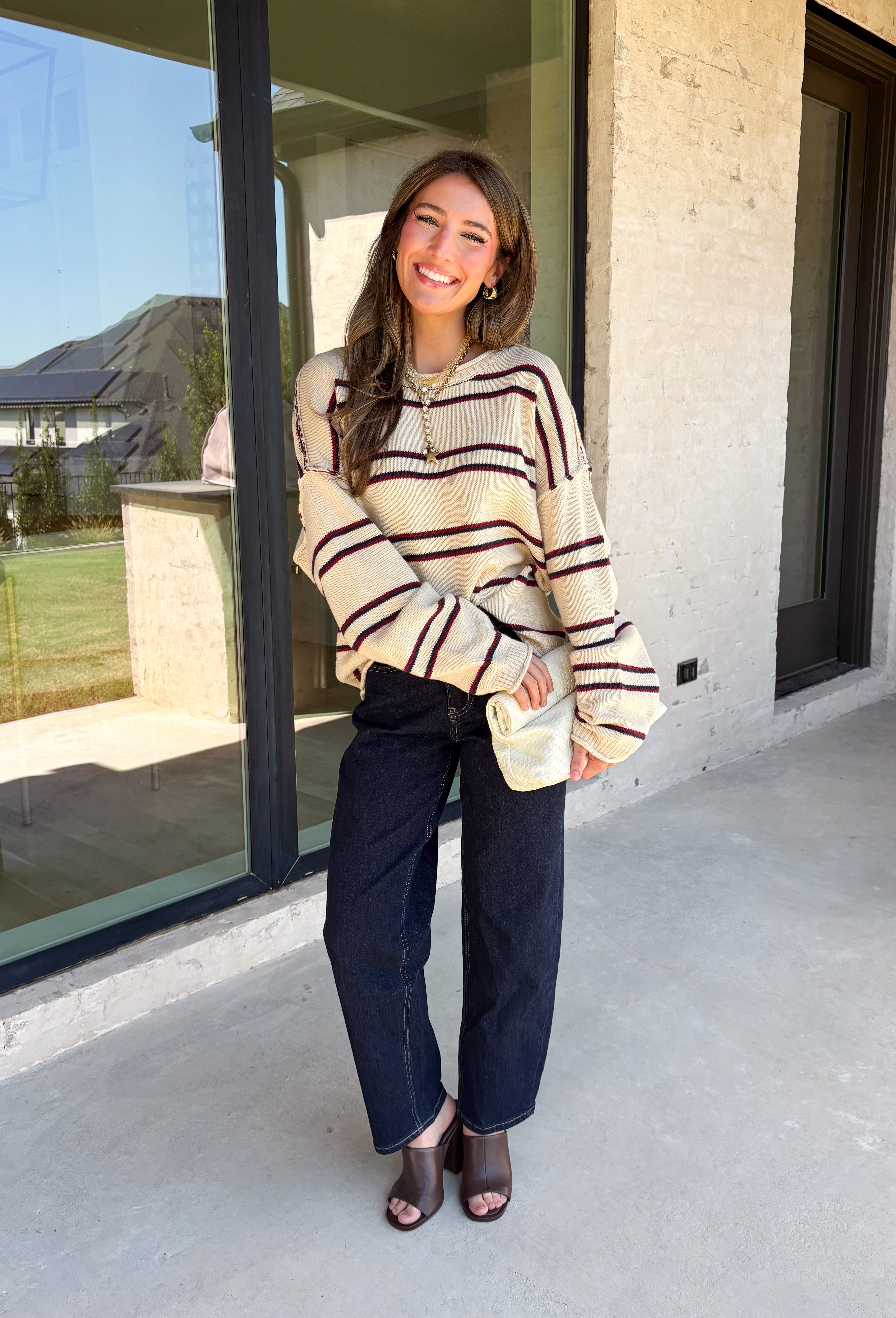 Nothing says cozy season quite like a classic striped sweater! This soft neutral knit is accented with timeless navy and burgundy stripes, creating the perfect color combination for fall. Exposed hems give it a relaxed, lived-in feel, while the ribbed neckline, cuffs, and hem add a polished finish. Whether you're headed to a football game, a weekend getaway, or simply enjoying a crisp autumn day, this cozy sweater is one you'll love reaching for.