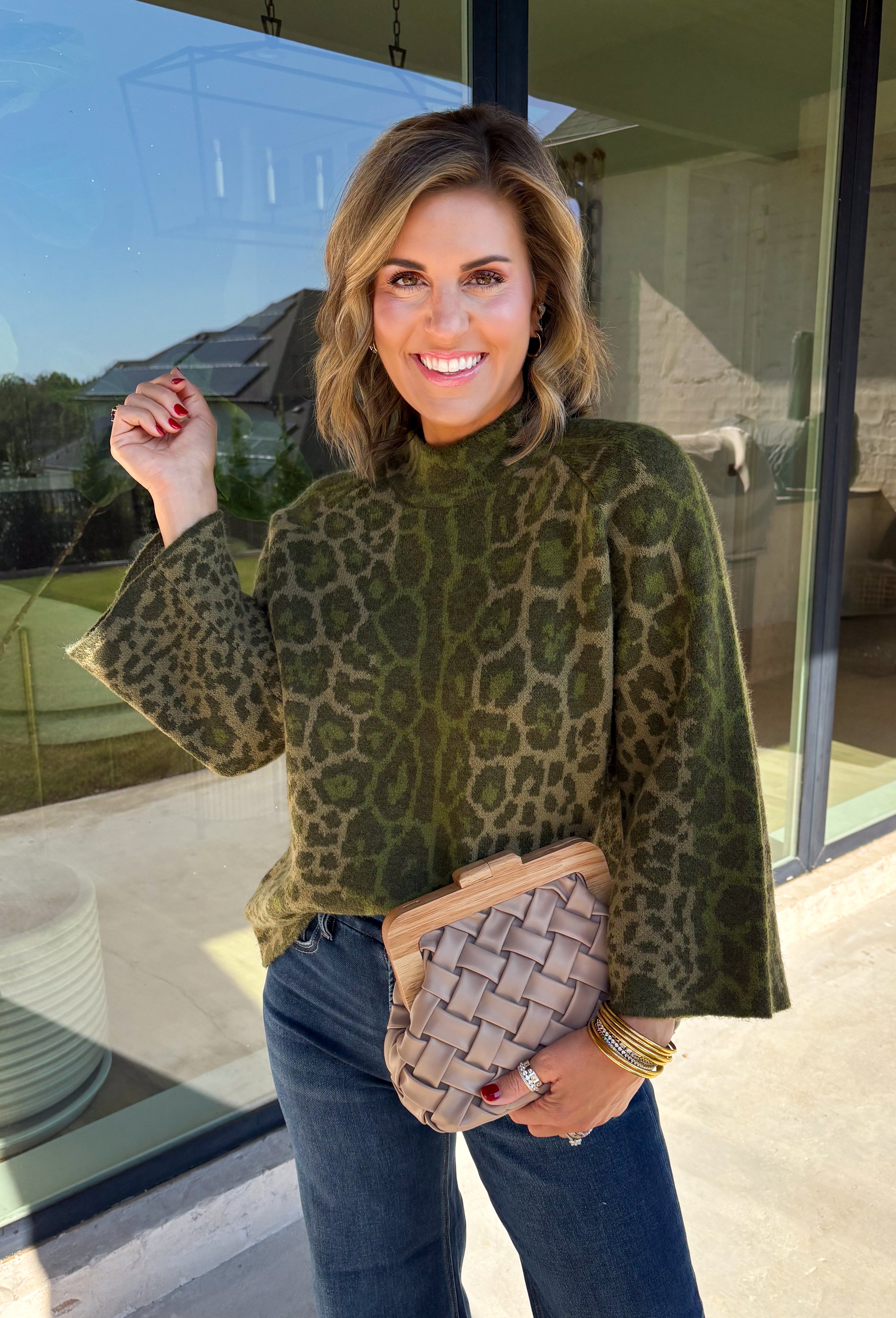 Bring a bold touch to your fall wardrobe with this cozy leopard sweater from Entro. Featuring a rich olive backdrop with a timeless leopard print, this effortlessly stylish knit is the perfect blend of classic and fun. The round neckline creates an easy, everyday silhouette, while the soft, cozy knit keeps you warm and comfortable on crisp autumn days. Whether you're headed to brunch, running errands, or enjoying a weekend getaway, this sweater is an easy favorite you'll wear on repeat.