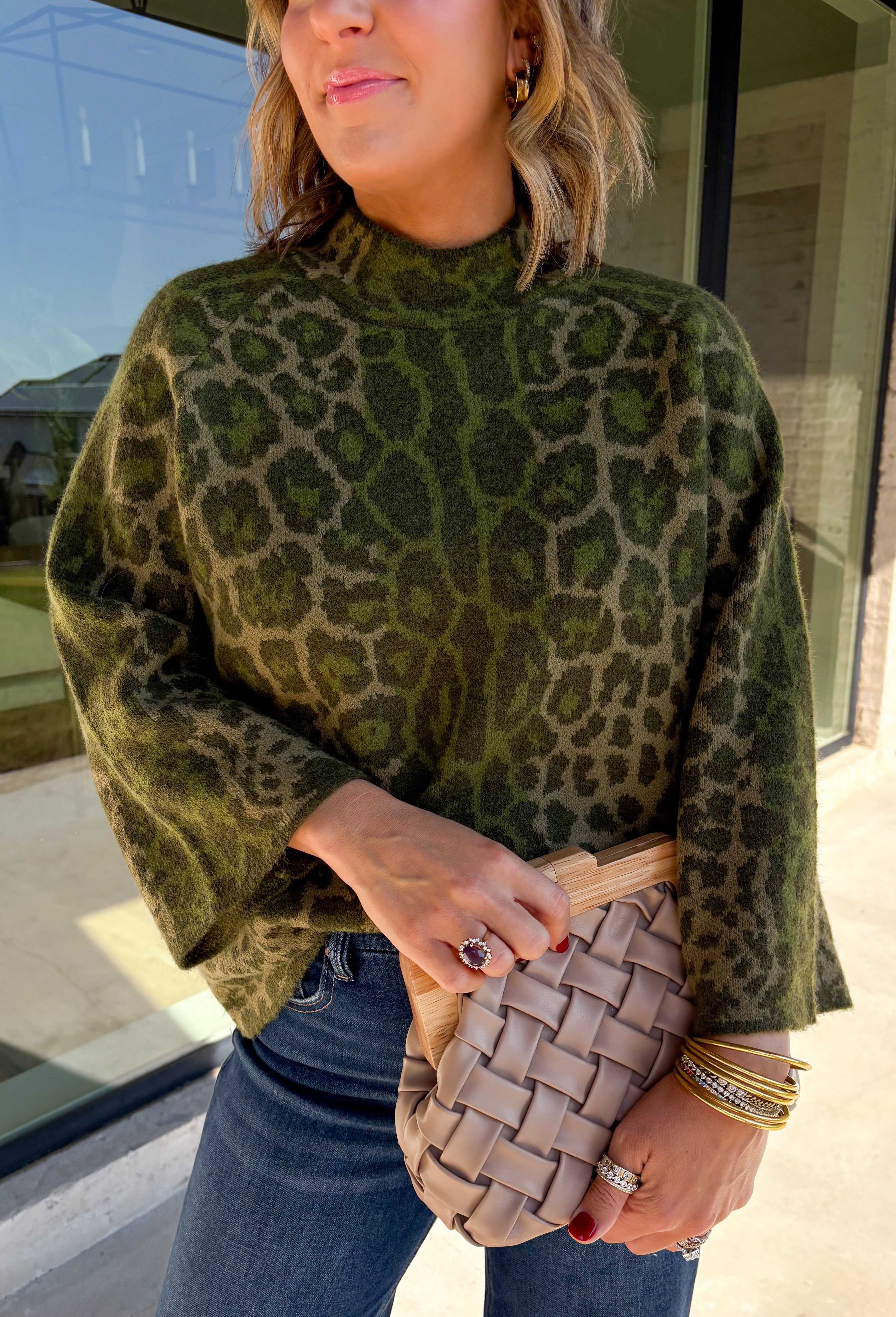 Bring a bold touch to your fall wardrobe with this cozy leopard sweater from Entro. Featuring a rich olive backdrop with a timeless leopard print, this effortlessly stylish knit is the perfect blend of classic and fun. The round neckline creates an easy, everyday silhouette, while the soft, cozy knit keeps you warm and comfortable on crisp autumn days. Whether you're headed to brunch, running errands, or enjoying a weekend getaway, this sweater is an easy favorite you'll wear on repeat.