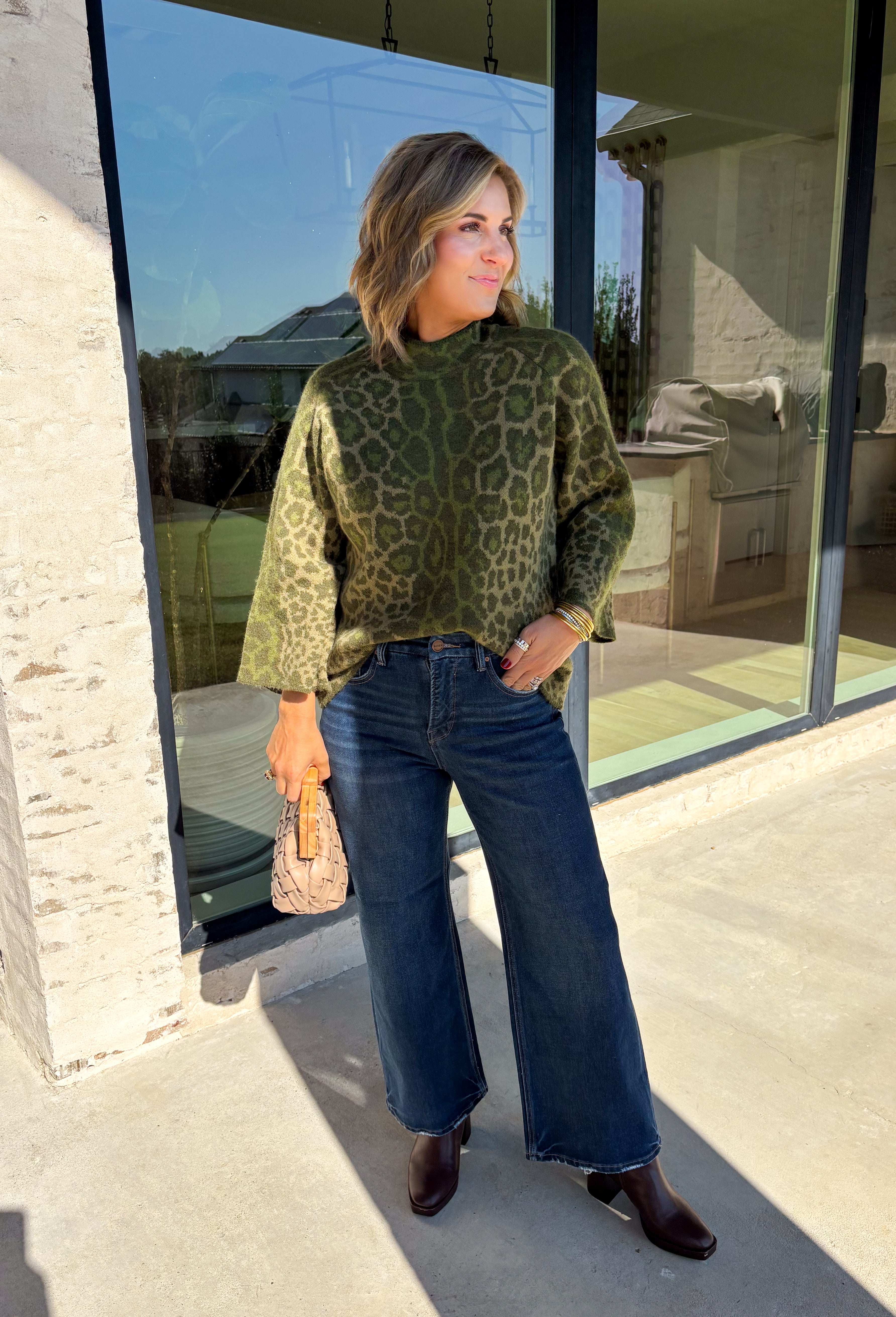 Bring a bold touch to your fall wardrobe with this cozy leopard sweater from Entro. Featuring a rich olive backdrop with a timeless leopard print, this effortlessly stylish knit is the perfect blend of classic and fun. The round neckline creates an easy, everyday silhouette, while the soft, cozy knit keeps you warm and comfortable on crisp autumn days. Whether you're headed to brunch, running errands, or enjoying a weekend getaway, this sweater is an easy favorite you'll wear on repeat.