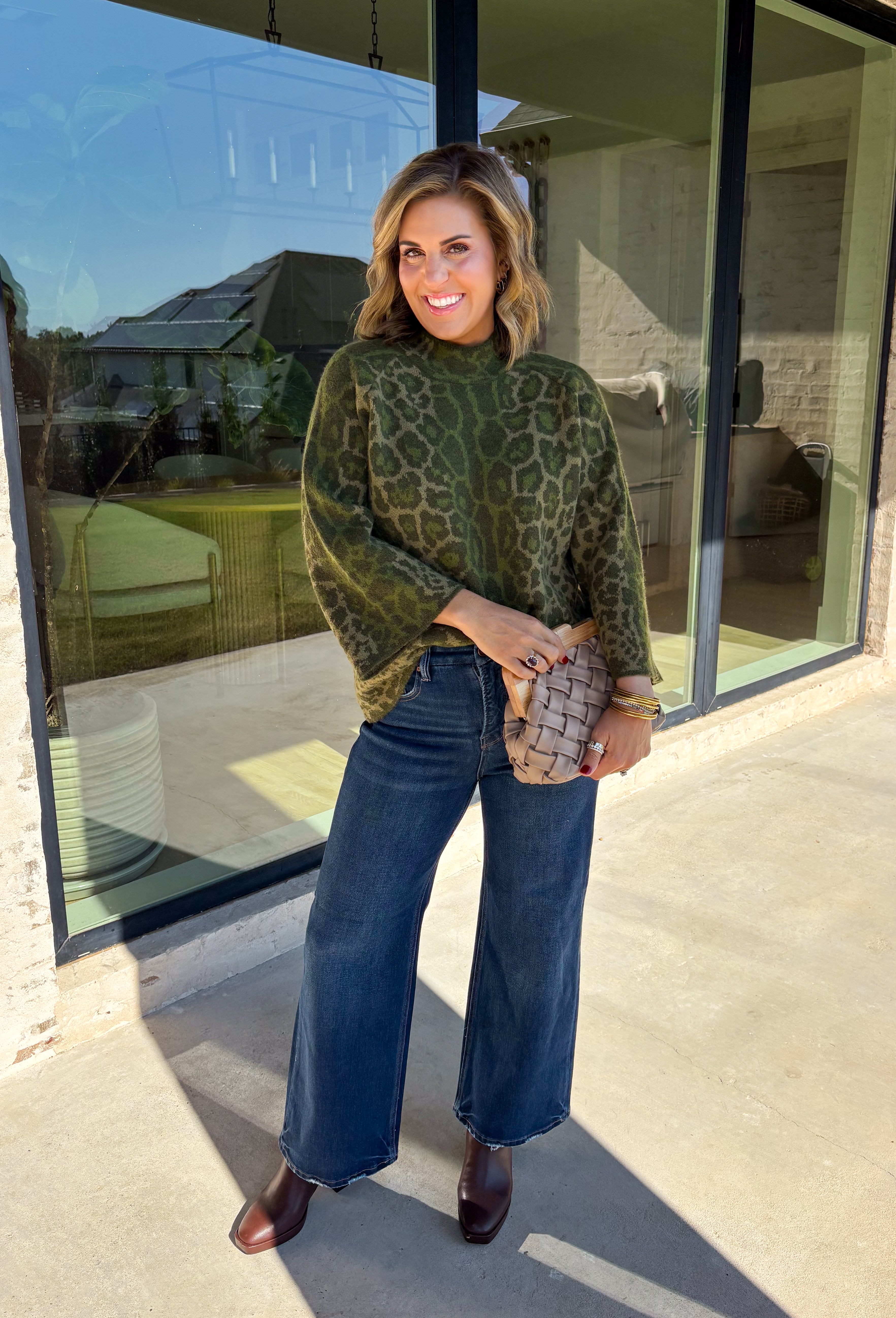 Bring a bold touch to your fall wardrobe with this cozy leopard sweater from Entro. Featuring a rich olive backdrop with a timeless leopard print, this effortlessly stylish knit is the perfect blend of classic and fun. The round neckline creates an easy, everyday silhouette, while the soft, cozy knit keeps you warm and comfortable on crisp autumn days. Whether you're headed to brunch, running errands, or enjoying a weekend getaway, this sweater is an easy favorite you'll wear on repeat.
