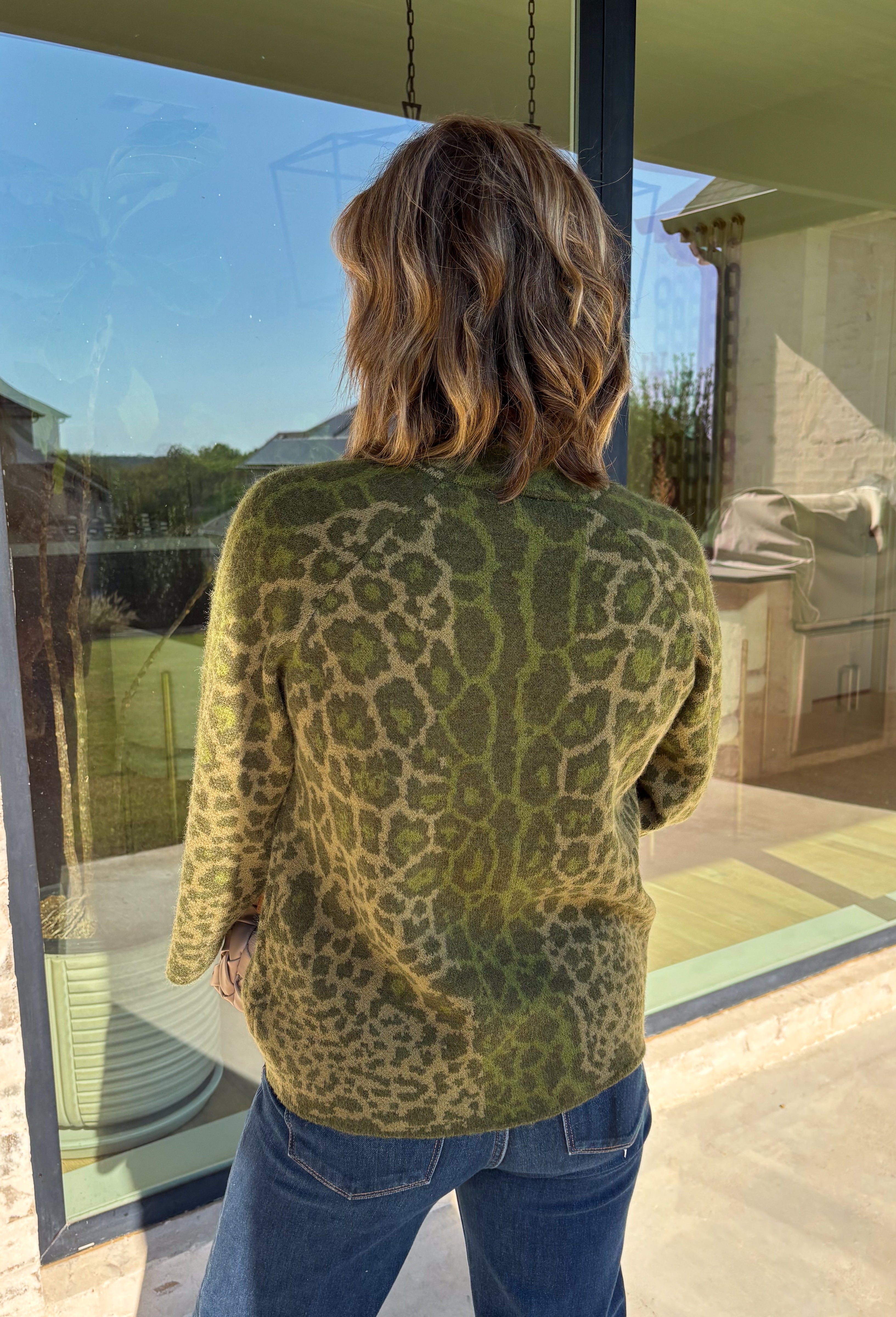 Bring a bold touch to your fall wardrobe with this cozy leopard sweater from Entro. Featuring a rich olive backdrop with a timeless leopard print, this effortlessly stylish knit is the perfect blend of classic and fun. The round neckline creates an easy, everyday silhouette, while the soft, cozy knit keeps you warm and comfortable on crisp autumn days. Whether you're headed to brunch, running errands, or enjoying a weekend getaway, this sweater is an easy favorite you'll wear on repeat.