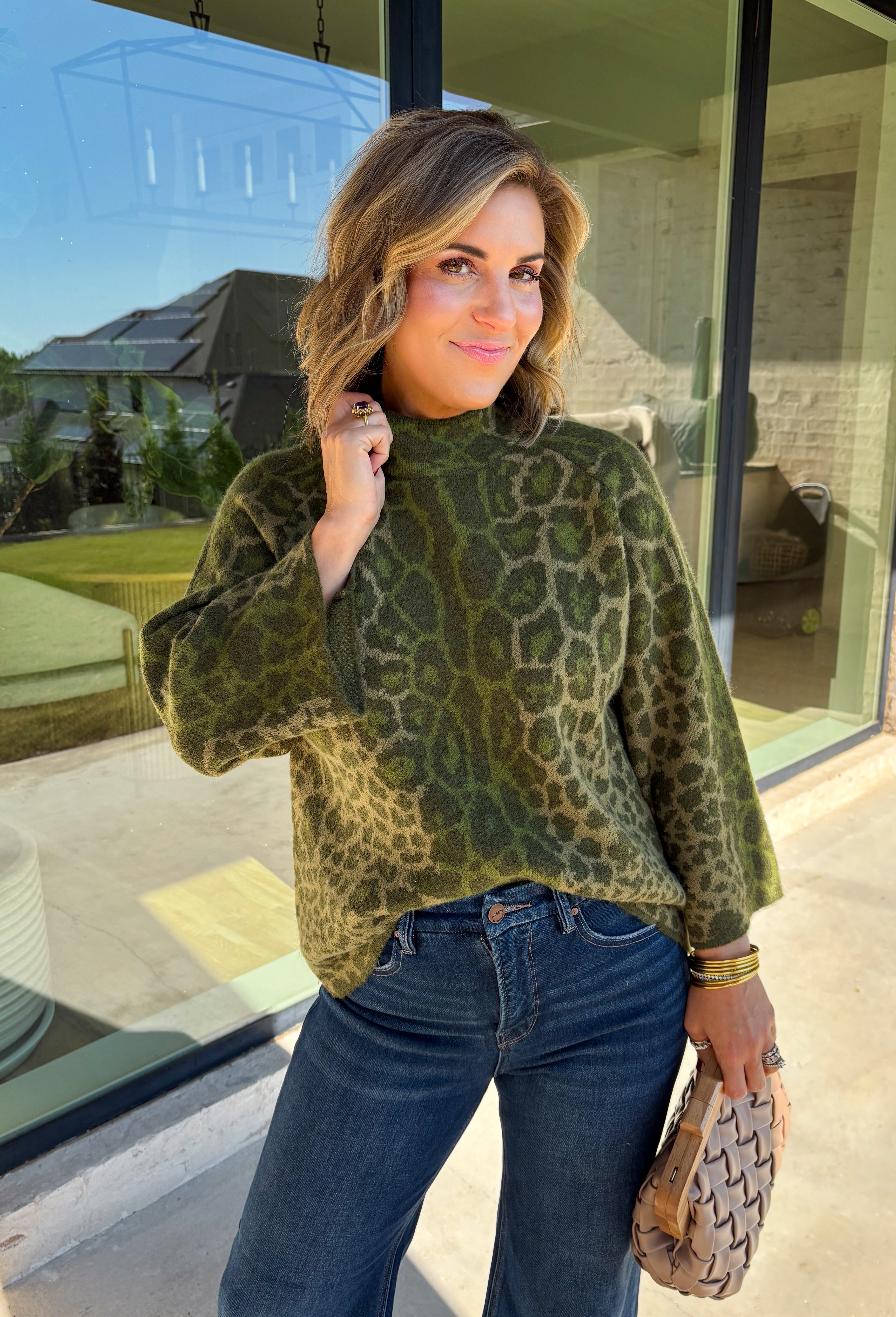 Bring a bold touch to your fall wardrobe with this cozy leopard sweater from Entro. Featuring a rich olive backdrop with a timeless leopard print, this effortlessly stylish knit is the perfect blend of classic and fun. The round neckline creates an easy, everyday silhouette, while the soft, cozy knit keeps you warm and comfortable on crisp autumn days. Whether you're headed to brunch, running errands, or enjoying a weekend getaway, this sweater is an easy favorite you'll wear on repeat.