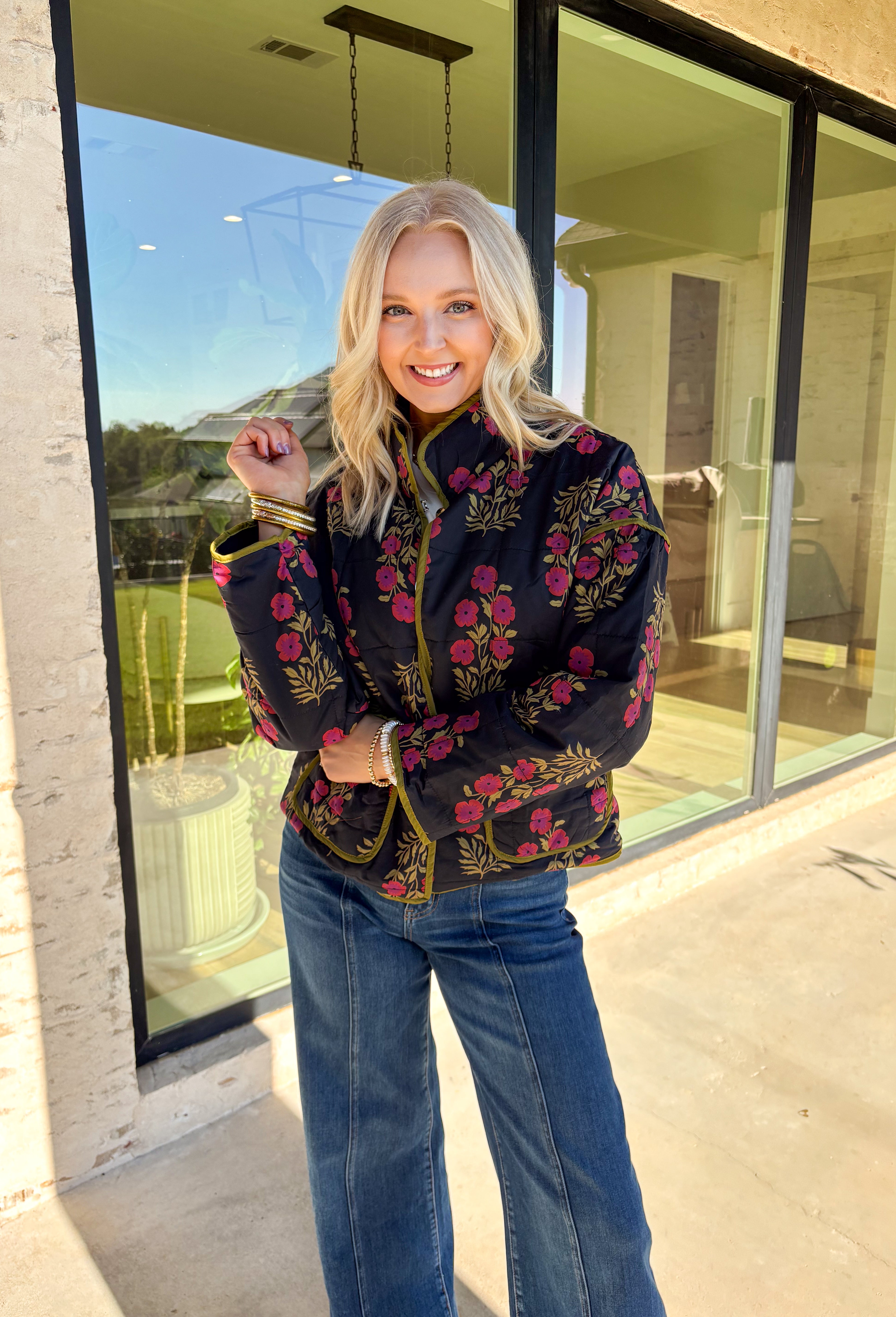 Wrap up in seasonal style with this black quilted jacket featuring a rich botanical print in olive and burgundy tones. Contrast binding highlights the edges for a polished finish, while front patch pockets add both function and charm. The hook-and-eye closure keeps the silhouette clean and simple, and the all-cotton design makes it cozy yet breathable for cool fall days. Whether layered over a sweater or paired with a casual tee, this jacket is a statement piece you’ll wear on repeat.
