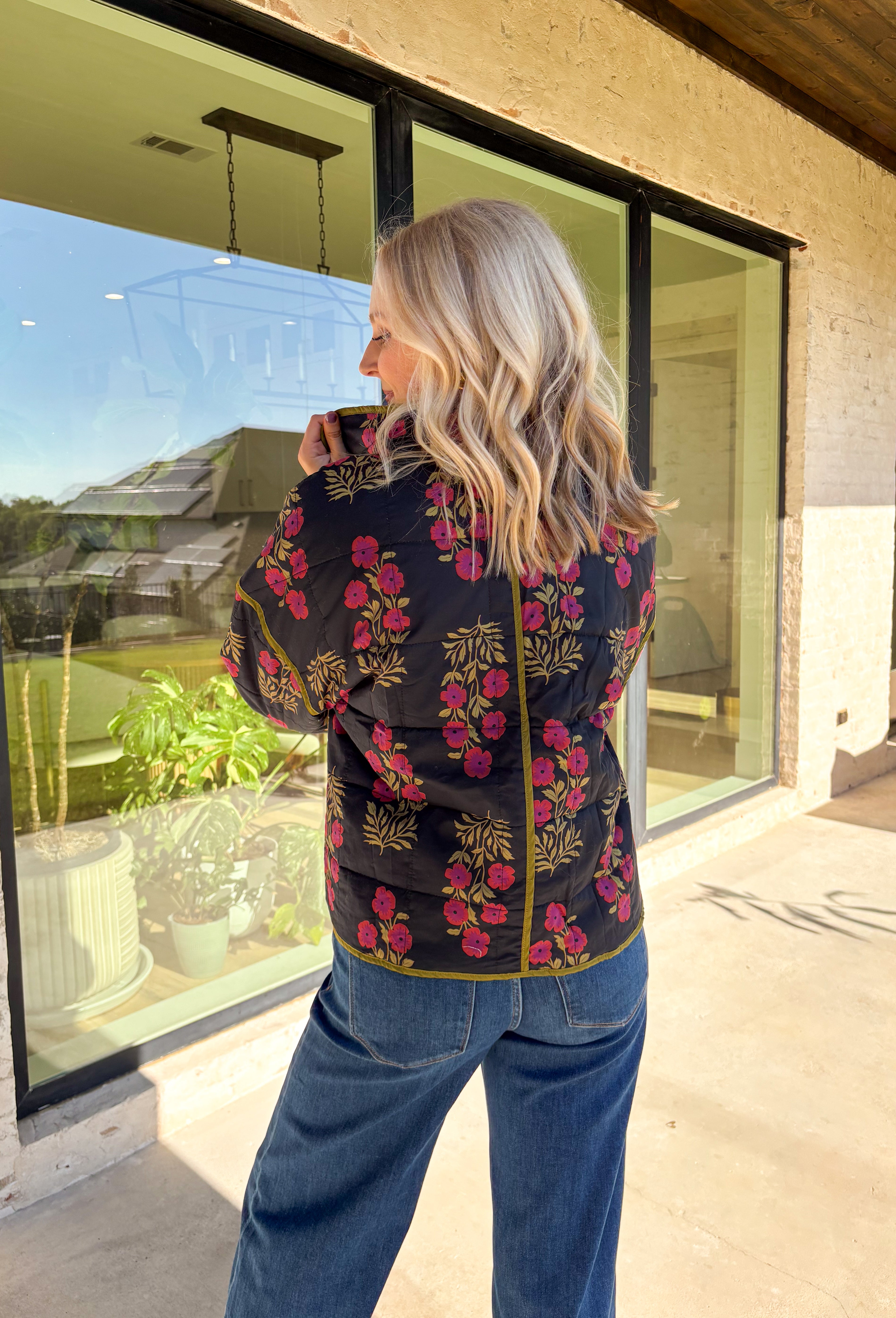 Wrap up in seasonal style with this black quilted jacket featuring a rich botanical print in olive and burgundy tones. Contrast binding highlights the edges for a polished finish, while front patch pockets add both function and charm. The hook-and-eye closure keeps the silhouette clean and simple, and the all-cotton design makes it cozy yet breathable for cool fall days. Whether layered over a sweater or paired with a casual tee, this jacket is a statement piece you’ll wear on repeat.