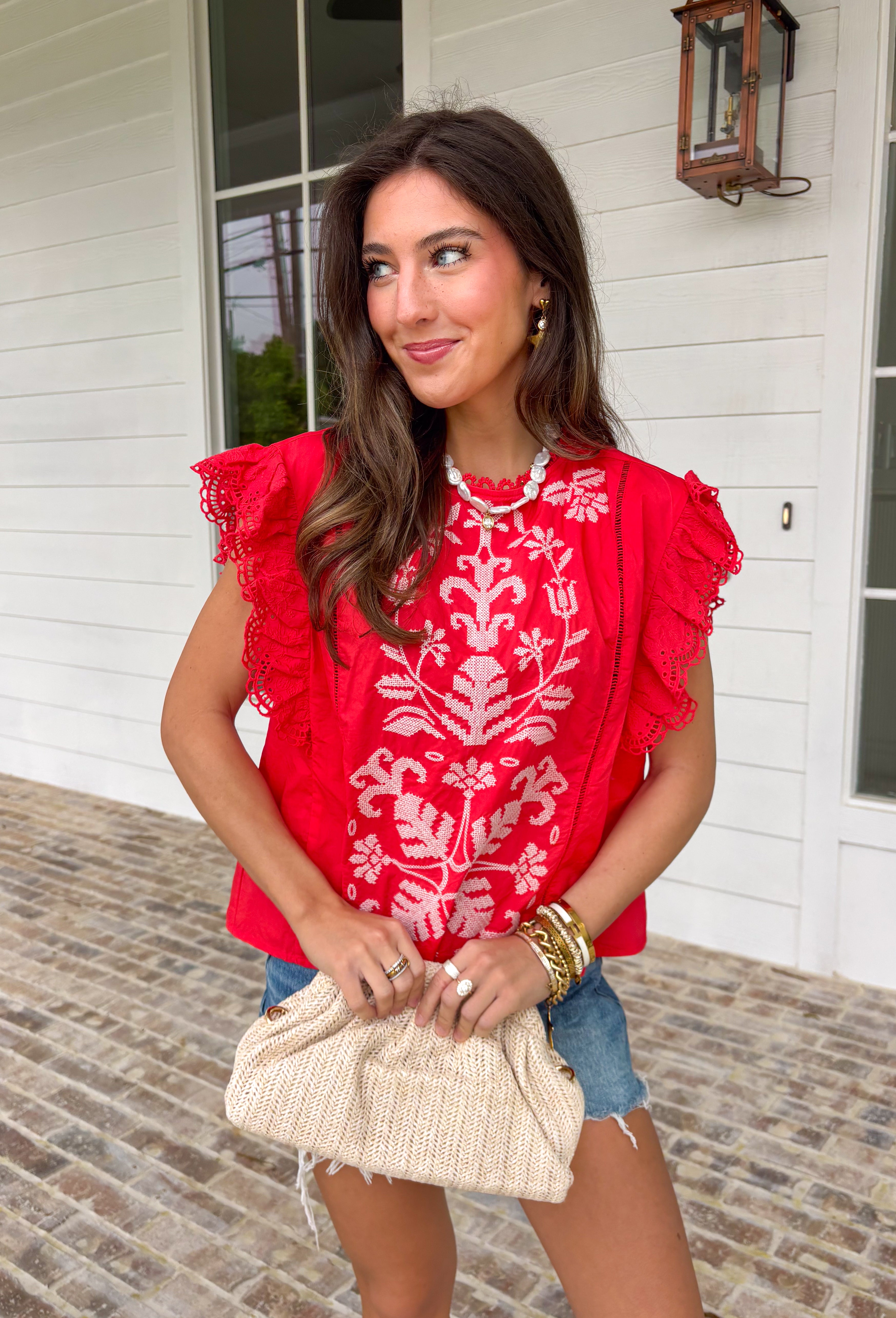 This red short sleeve top is the perfect pop of color for spring days ahead. Designed with neutral embroidery along the top, it brings just the right amount of contrast and charm. The lace sleeves add a soft, feminine touch, while the scalloped lace neckline gives it a beautifully detailed finish. Ladder trim detailing across the top adds texture and dimension, and the keyhole closure in the back completes the look with a subtle, polished detail. 