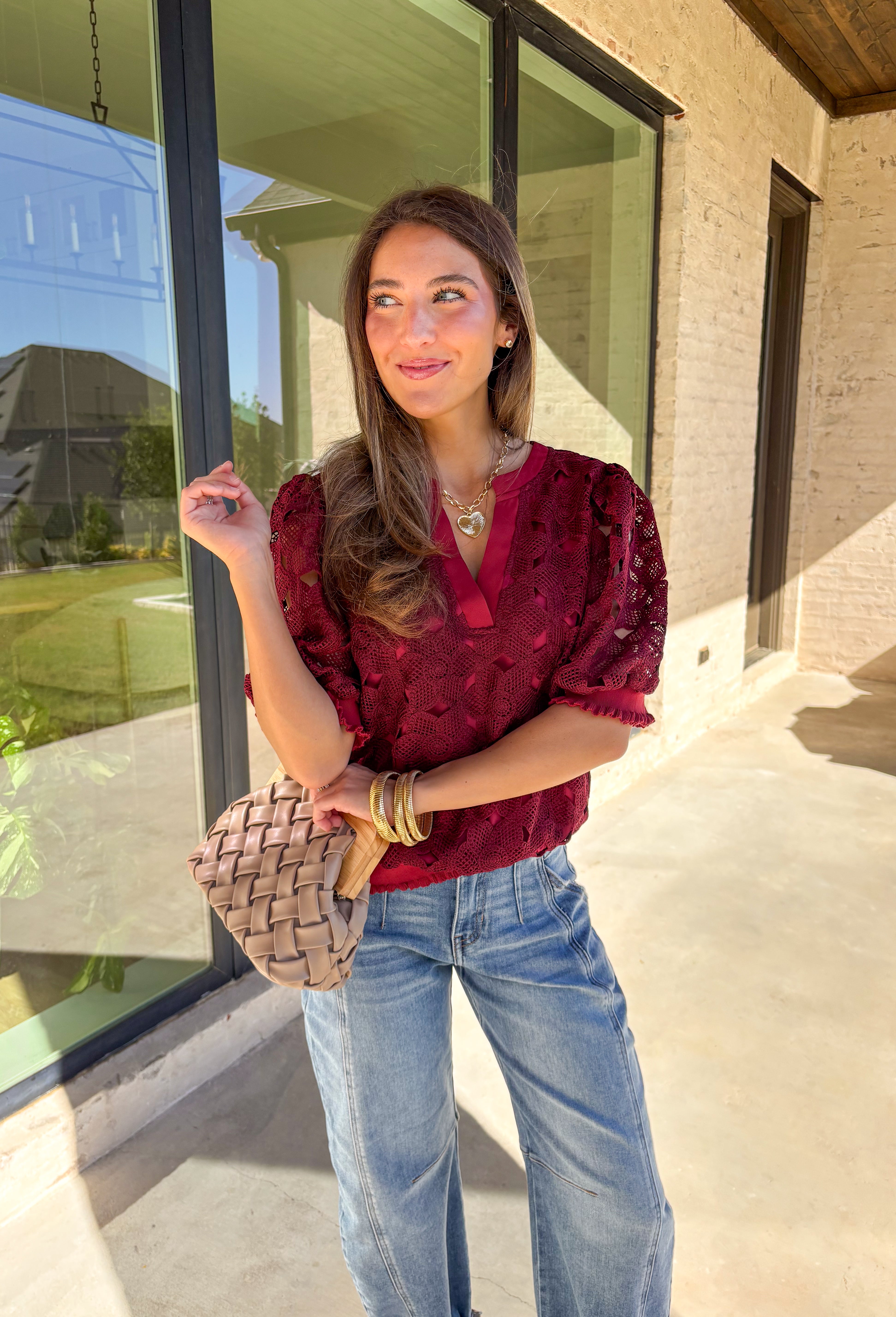 Romantic and feminine, this burgundy crochet lace overlay top by Voy is the perfect piece to elevate your fall wardrobe. The delicate lace design gives it beautiful texture, while the short sleeves and v-neckline add an effortless touch. Lettuce trim along the sleeves and hemline adds a soft, finished detail that keeps the look both classic and fresh.