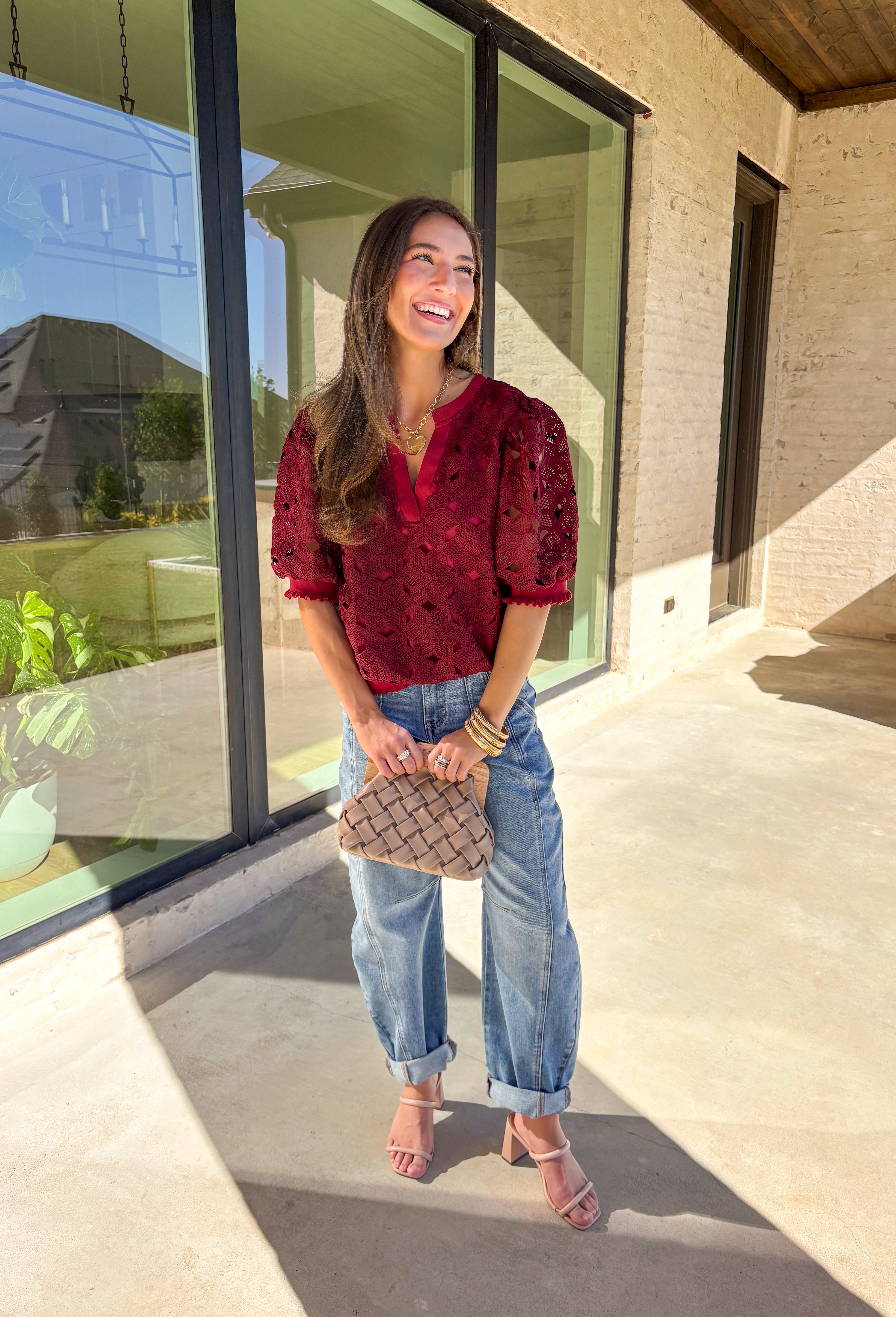 Romantic and feminine, this burgundy crochet lace overlay top by Voy is the perfect piece to elevate your fall wardrobe. The delicate lace design gives it beautiful texture, while the short sleeves and v-neckline add an effortless touch. Lettuce trim along the sleeves and hemline adds a soft, finished detail that keeps the look both classic and fresh.