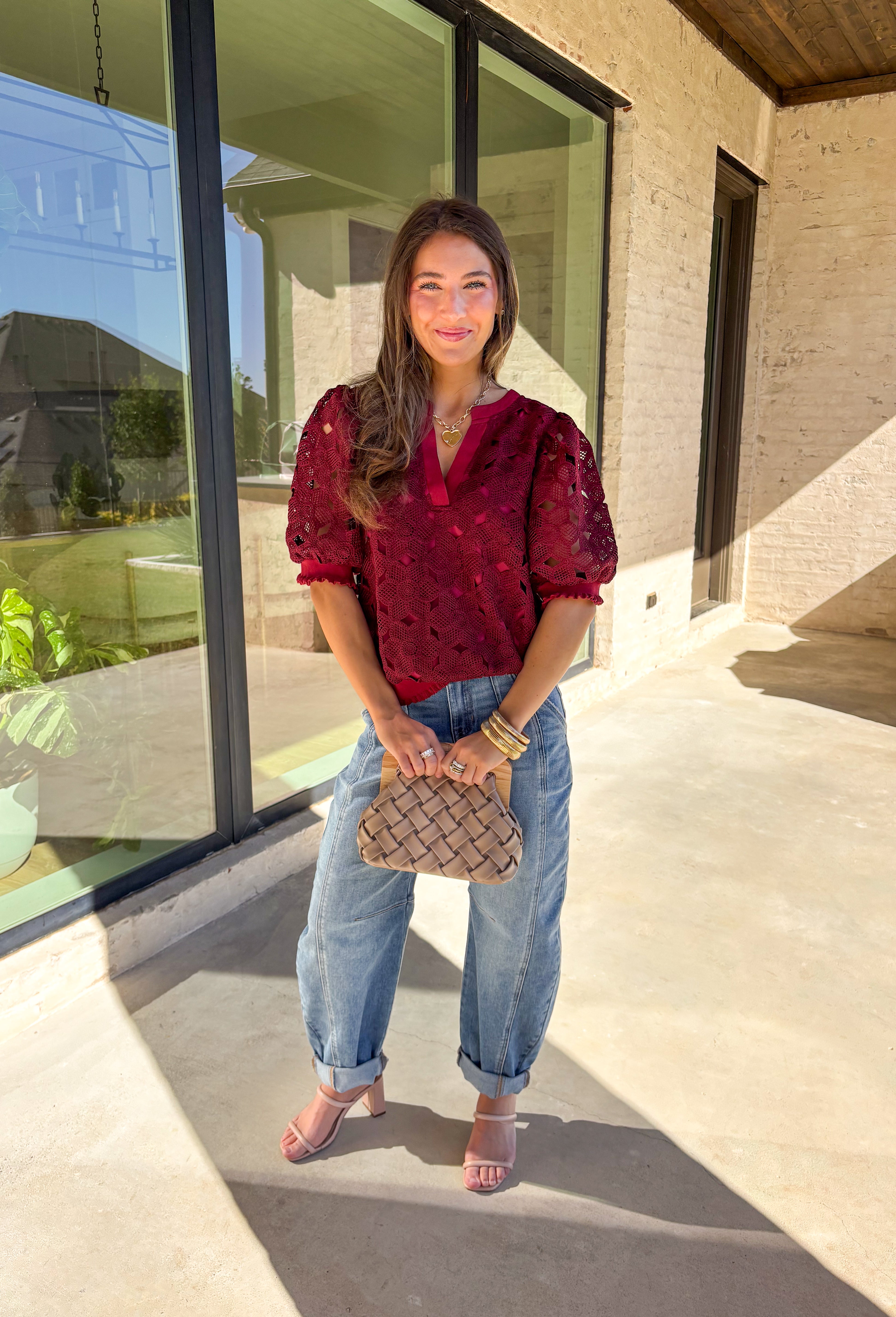 Romantic and feminine, this burgundy crochet lace overlay top by Voy is the perfect piece to elevate your fall wardrobe. The delicate lace design gives it beautiful texture, while the short sleeves and v-neckline add an effortless touch. Lettuce trim along the sleeves and hemline adds a soft, finished detail that keeps the look both classic and fresh.