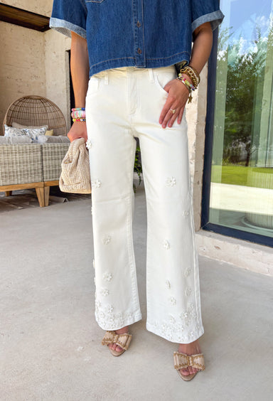 These cream wide leg jeans are what spring outfit dreams are made of! Designed with flattering tummy control and the prettiest monochromatic textured floral print, they bring just the right amount of feminine detail while still feeling easy and wearable. The pearl-centered blooms add such a special touch—like a little surprise moment that sets these apart from your everyday denim. With a comfortable stretch and breezy wide leg fit, they’re perfect for everything from brunch dates to weekend plans. 