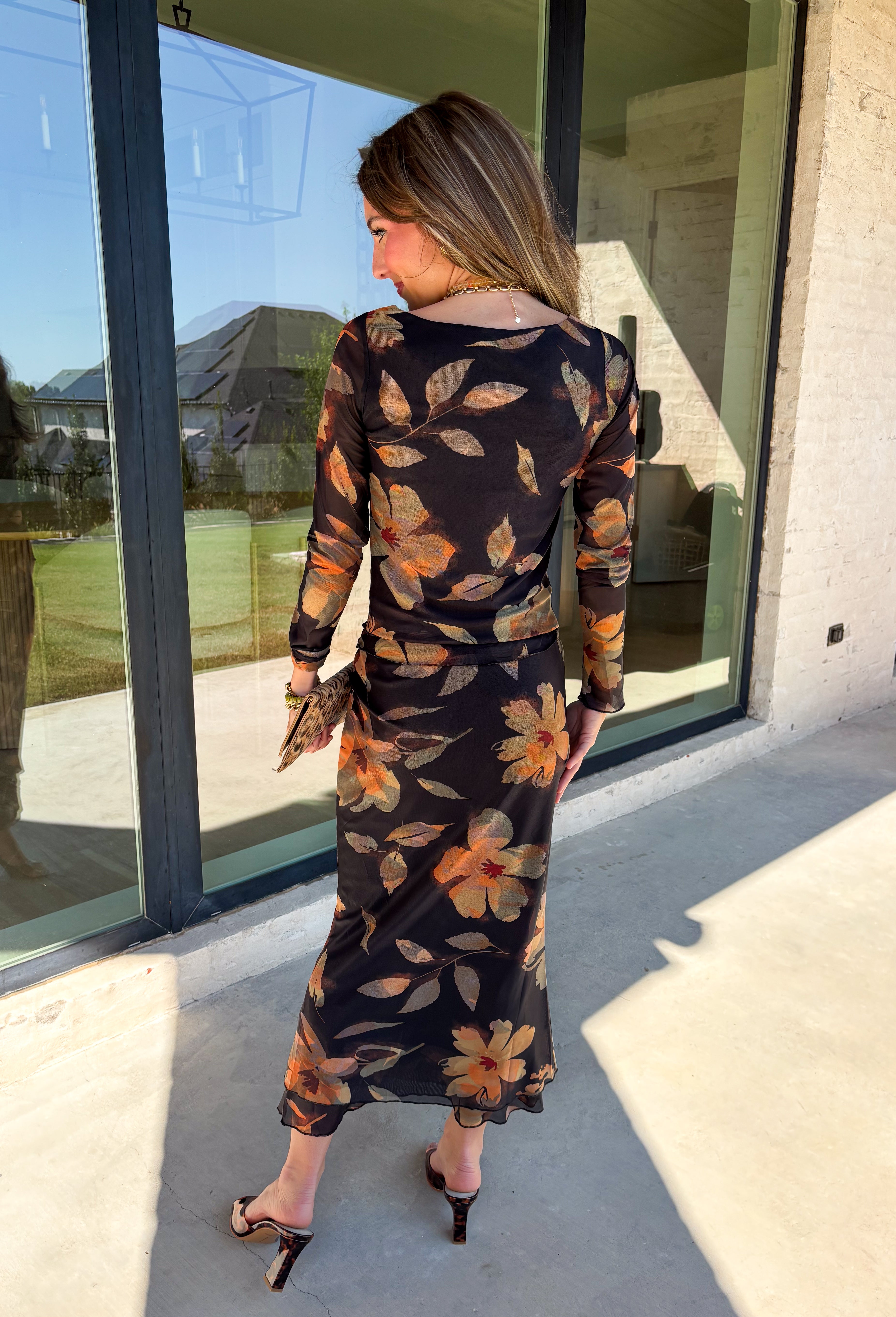 Effortlessly elegant and endlessly versatile, this matching set from Hyfve is a standout for the season. Featuring a black backdrop with a beautiful neutral floral print in muted shades of orange and olive, this two-piece outfit offers a timeless look you'll love wearing together or mixing and matching with other favorites in your wardrobe.