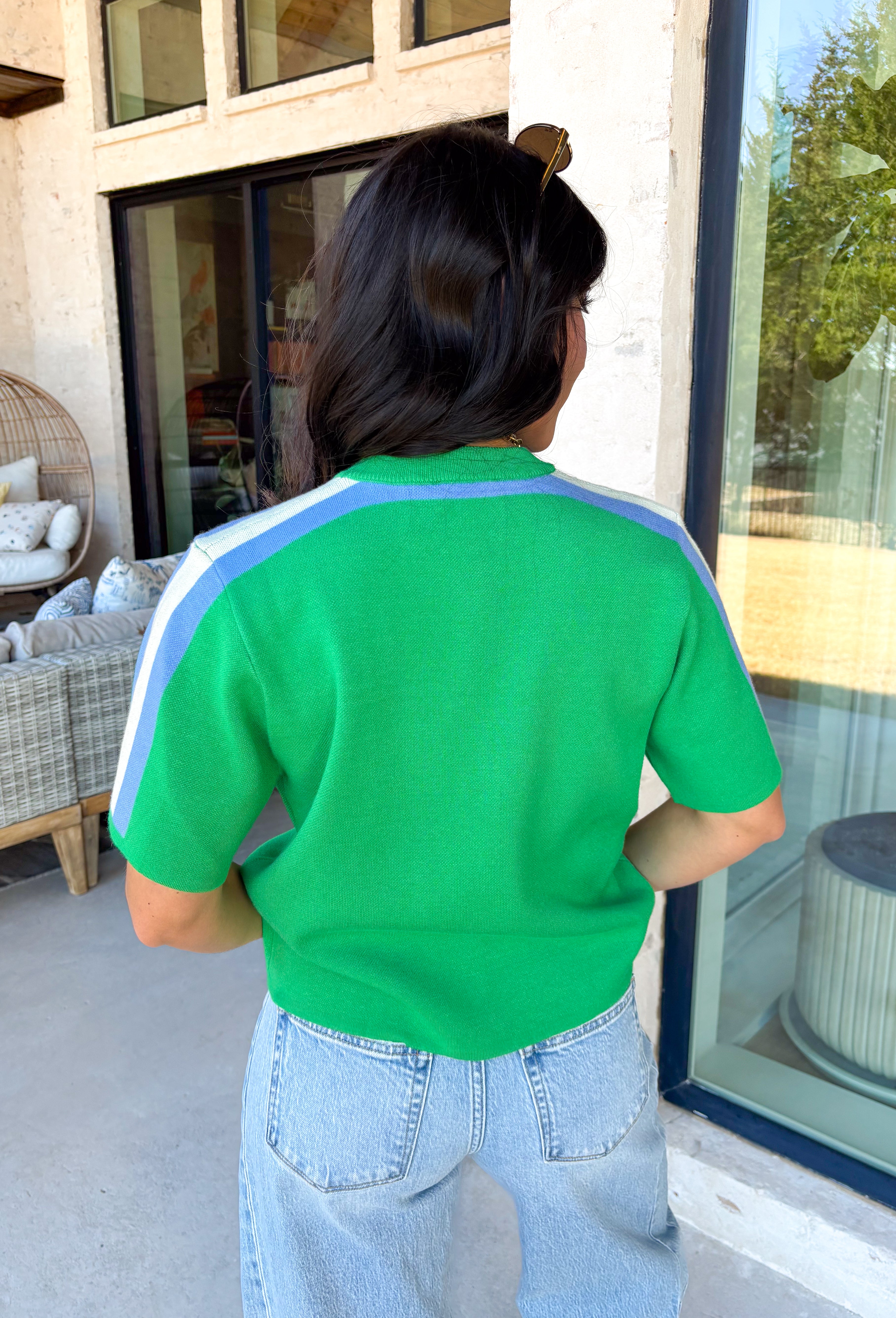 Sporty meets spring in this green short sleeve knit top by Entro. Designed with a soft, lightweight knit feel, it features a bold blue and white contrast stripe down the sides for a fun pop of color and a flattering, elongating look. Easy to dress up or down, this top is perfect for casual spring days when you still want something polished and comfortable.