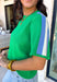 Sporty meets spring in this green short sleeve knit top by Entro. Designed with a soft, lightweight knit feel, it features a bold blue and white contrast stripe down the sides for a fun pop of color and a flattering, elongating look. Easy to dress up or down, this top is perfect for casual spring days when you still want something polished and comfortable.