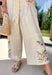 This neutral sleeveless jumpsuit is giving effortless spring charm with the prettiest embroidered details. Designed with colorful floral stitching in shades of blue, sage green, pink, and yellow, it features embroidery along the front and down the legs for a look that truly stands out. The ladder trim throughout adds subtle texture, while the lace scallop trim at the sleeves brings a soft, feminine finish. 