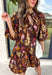 Capture the beauty of the season in this effortlessly feminine dress from Entro. Designed with a rich brown backdrop and a fall-inspired floral print with delicate leaf-like details, this charming dress is perfect for everything from brunch dates to seasonal celebrations. The flattering v-neckline features sweet tie details at the neck and bust, while decorative front buttons add timeless appeal. 