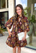 Capture the beauty of the season in this effortlessly feminine dress from Entro. Designed with a rich brown backdrop and a fall-inspired floral print with delicate leaf-like details, this charming dress is perfect for everything from brunch dates to seasonal celebrations. The flattering v-neckline features sweet tie details at the neck and bust, while decorative front buttons add timeless appeal. 