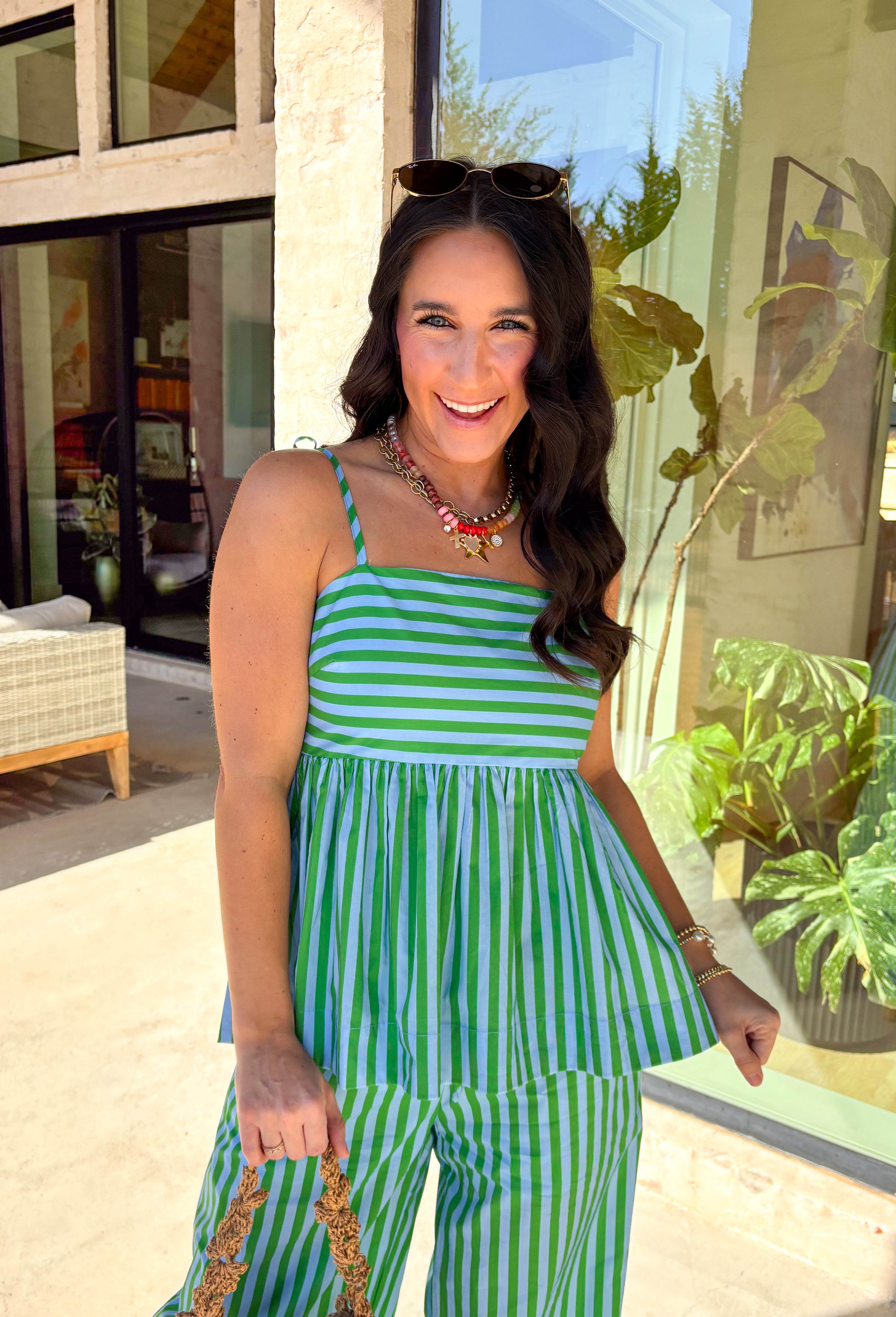 Light, breezy, and made for sunny days—this striped sleeveless top is the definition of easy spring style. The green and light blue stripes feel fresh and playful, while the adjustable tie shoulder straps let you customize the fit (and add the cutest little detail). Smocking at the back gives it a comfy, flexible feel that hugs just right without feeling tight. Pair it with the matching pants or white jeans, and a flowy skirt.