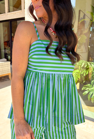 Light, breezy, and made for sunny days—this striped sleeveless top is the definition of easy spring style. The green and light blue stripes feel fresh and playful, while the adjustable tie shoulder straps let you customize the fit (and add the cutest little detail). Smocking at the back gives it a comfy, flexible feel that hugs just right without feeling tight. Pair it with the matching pants or white jeans, and a flowy skirt.
