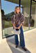 Neutral gets a little wild with this brown and cream zebra print blouse from Entro. The warm color combination makes the statement print easy to style while fitting perfectly into the transition from fall into winter. A stand collar and partial button-front closure give the lightweight silhouette a classic touch, while gathered detailing at the shoulders and back adds shape and movement.