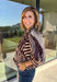 Neutral gets a little wild with this brown and cream zebra print blouse from Entro. The warm color combination makes the statement print easy to style while fitting perfectly into the transition from fall into winter. A stand collar and partial button-front closure give the lightweight silhouette a classic touch, while gathered detailing at the shoulders and back adds shape and movement.