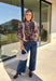 Neutral gets a little wild with this brown and cream zebra print blouse from Entro. The warm color combination makes the statement print easy to style while fitting perfectly into the transition from fall into winter. A stand collar and partial button-front closure give the lightweight silhouette a classic touch, while gathered detailing at the shoulders and back adds shape and movement.
