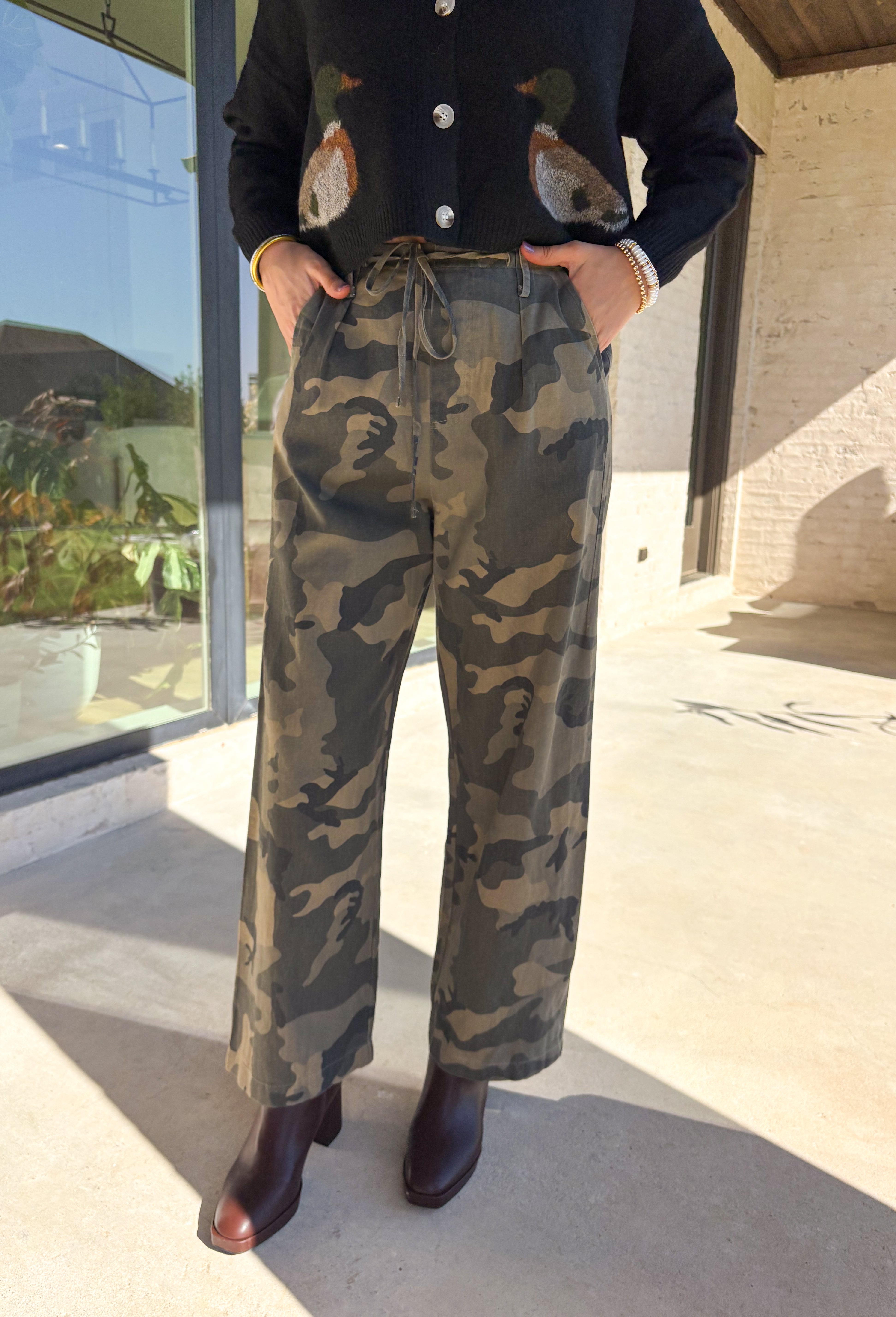 Keep it cool and casual with these wide leg camo pants by Mustard Seed. Designed with a relaxed silhouette and a lightweight feel, these pants feature an elastic waistband with a front tie detail for added comfort and style. The camo print gives them a trendy edge, making them perfect for all season long.