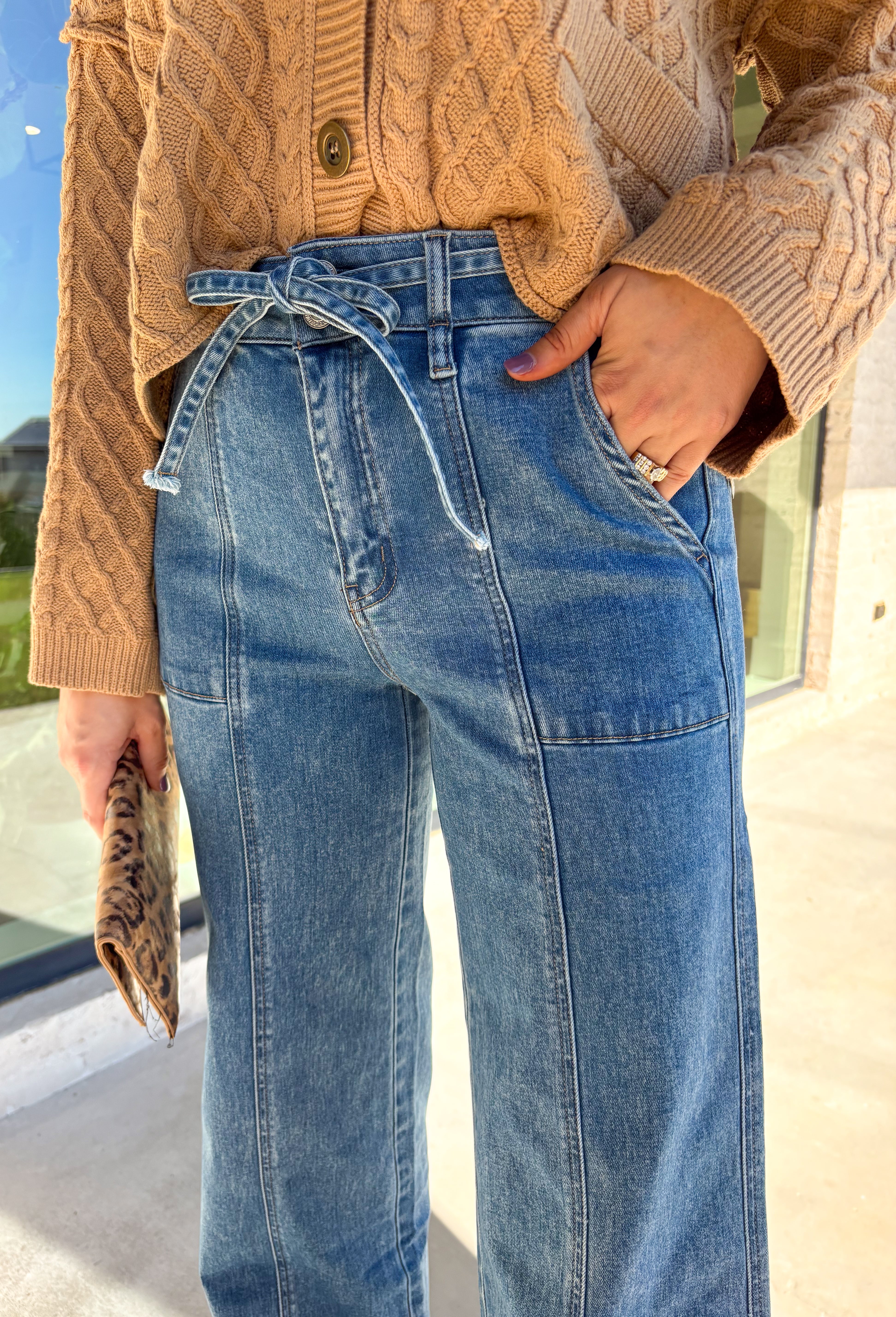 These jeans are here to make a statement. With their super high waist, tie waistband, and sweeping full-length wide leg, they give off major vintage-inspired vibes while keeping things modern and flattering. The medium wash makes them endlessly versatile, and the 34" inseam means they pair beautifully with heels, wedges, or platforms. Soft with a hint of stretch, they’re the perfect mix of structured and comfortable—ready to elevate your fall denim lineup.