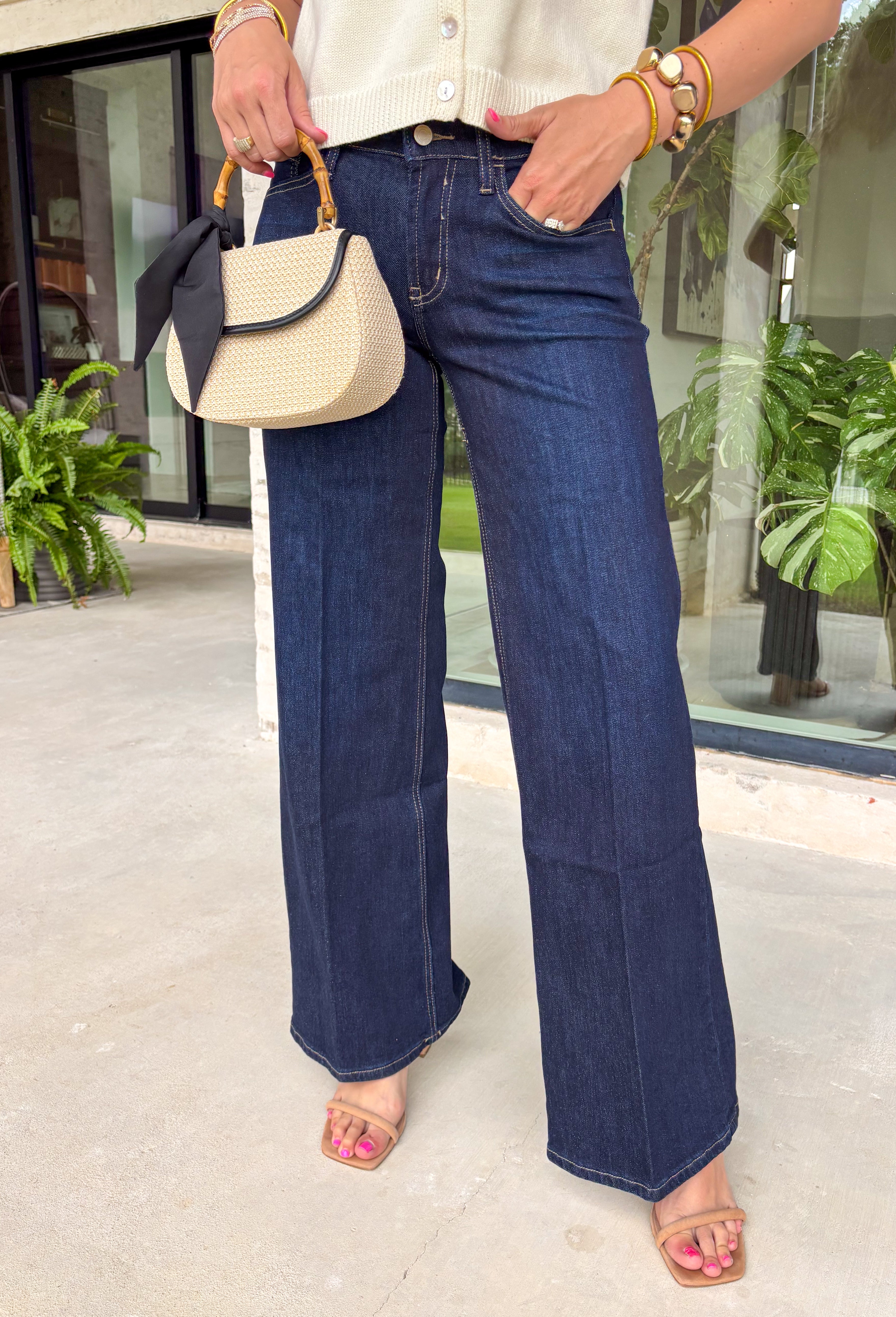 A pair of dark wash jeans is a wardrobe essential, and this style checks all the boxes! The rich dark wash gives these jeans a polished, elevated look, while the wide leg silhouette keeps them effortlessly on trend. Designed with a comfortable mid-rise fit and just the right amount of stretch, they're perfect for everything from workdays to weekend plans. Easy to dress up or down, these versatile jeans pair beautifully with cozy sweaters, tailored blouses, graphic tees, and everything in between. 
