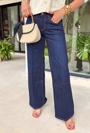 A pair of dark wash jeans is a wardrobe essential, and this style checks all the boxes! The rich dark wash gives these jeans a polished, elevated look, while the wide leg silhouette keeps them effortlessly on trend. Designed with a comfortable mid-rise fit and just the right amount of stretch, they're perfect for everything from workdays to weekend plans. Easy to dress up or down, these versatile jeans pair beautifully with cozy sweaters, tailored blouses, graphic tees, and everything in between. 