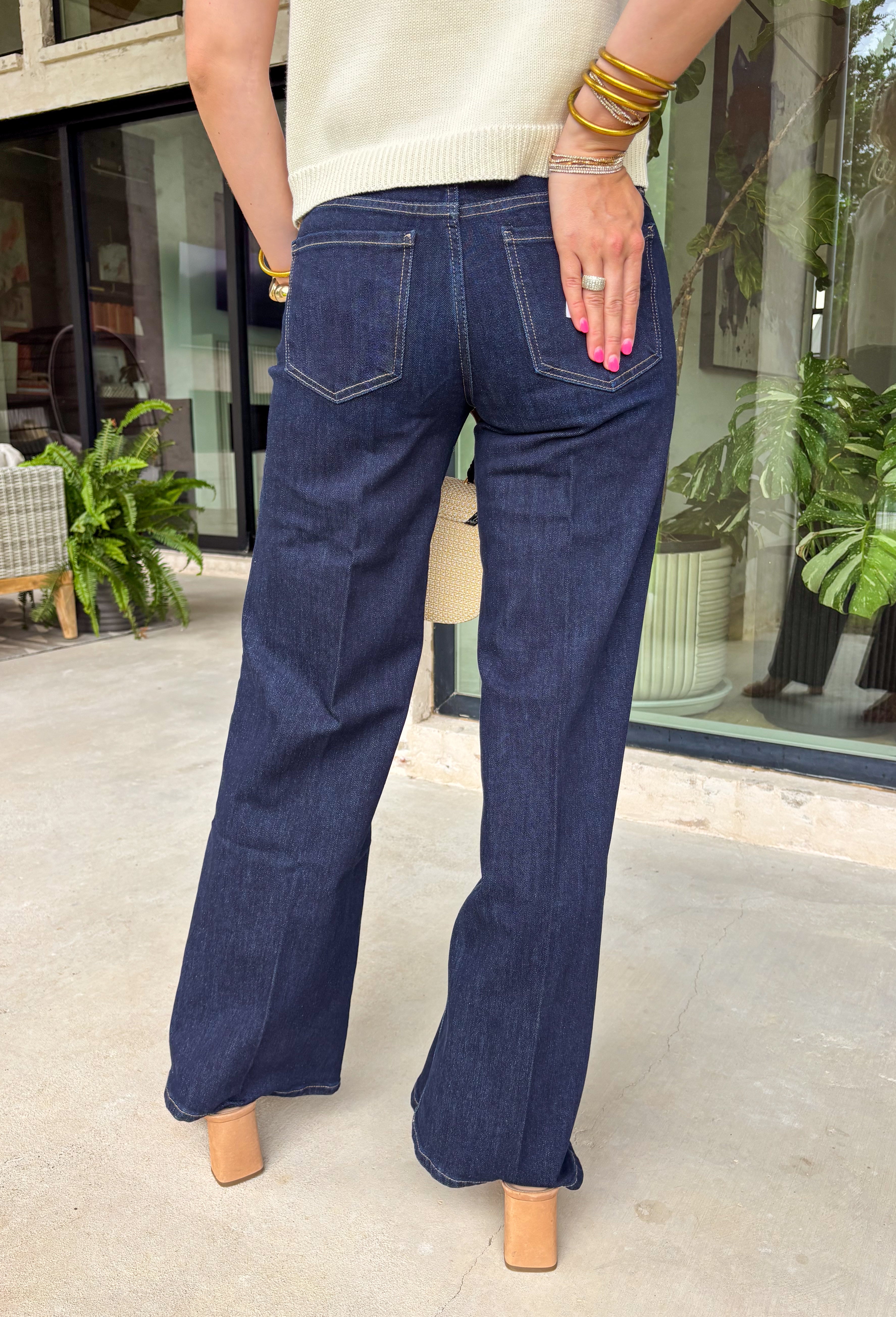 A pair of dark wash jeans is a wardrobe essential, and this style checks all the boxes! The rich dark wash gives these jeans a polished, elevated look, while the wide leg silhouette keeps them effortlessly on trend. Designed with a comfortable mid-rise fit and just the right amount of stretch, they're perfect for everything from workdays to weekend plans. Easy to dress up or down, these versatile jeans pair beautifully with cozy sweaters, tailored blouses, graphic tees, and everything in between. 