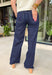 A pair of dark wash jeans is a wardrobe essential, and this style checks all the boxes! The rich dark wash gives these jeans a polished, elevated look, while the wide leg silhouette keeps them effortlessly on trend. Designed with a comfortable mid-rise fit and just the right amount of stretch, they're perfect for everything from workdays to weekend plans. Easy to dress up or down, these versatile jeans pair beautifully with cozy sweaters, tailored blouses, graphic tees, and everything in between. 