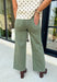 Meet the jeans that will instantly elevate your everyday wardrobe. Designed in a versatile olive wash, these wide leg jeans offer the perfect blend of comfort and effortless style. The removable self-tie waist lets you customize your look, whether you prefer a feminine bow or a clean, classic finish without it. Easy to dress up or down, they're the perfect pair for everything from busy weekdays to weekend brunch, fall festivals, and coffee dates.