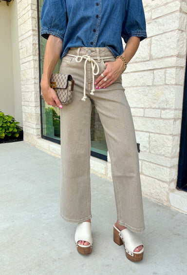 Meet the jeans that will instantly elevate your everyday wardrobe. Designed in a versatile taupe wash, these wide leg jeans offer the perfect blend of comfort and effortless style. The removable self-tie waist lets you customize your look, whether you prefer a feminine bow or a clean, classic finish without it. Easy to dress up or down, they're the perfect pair for everything from busy weekdays to weekend brunch, fall festivals, and coffee dates.