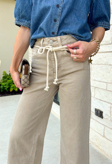 Meet the jeans that will instantly elevate your everyday wardrobe. Designed in a versatile taupe wash, these wide leg jeans offer the perfect blend of comfort and effortless style. The removable self-tie waist lets you customize your look, whether you prefer a feminine bow or a clean, classic finish without it. Easy to dress up or down, they're the perfect pair for everything from busy weekdays to weekend brunch, fall festivals, and coffee dates.