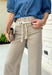 Meet the jeans that will instantly elevate your everyday wardrobe. Designed in a versatile taupe wash, these wide leg jeans offer the perfect blend of comfort and effortless style. The removable self-tie waist lets you customize your look, whether you prefer a feminine bow or a clean, classic finish without it. Easy to dress up or down, they're the perfect pair for everything from busy weekdays to weekend brunch, fall festivals, and coffee dates.