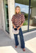 Soft, feminine, and full of seasonal charm, this floral blouse is an effortless addition to your fall wardrobe. Designed with a beautiful blush backdrop and a rich burgundy and tan floral print, this top brings together warm autumn hues in a timeless silhouette. The button-front design adds classic appeal, while the ruffle hem creates a flattering, feminine finish. Gathered detailing at the back yoke gives this blouse a relaxed, flowy fit that's perfect for everything from workdays to weekend outings.