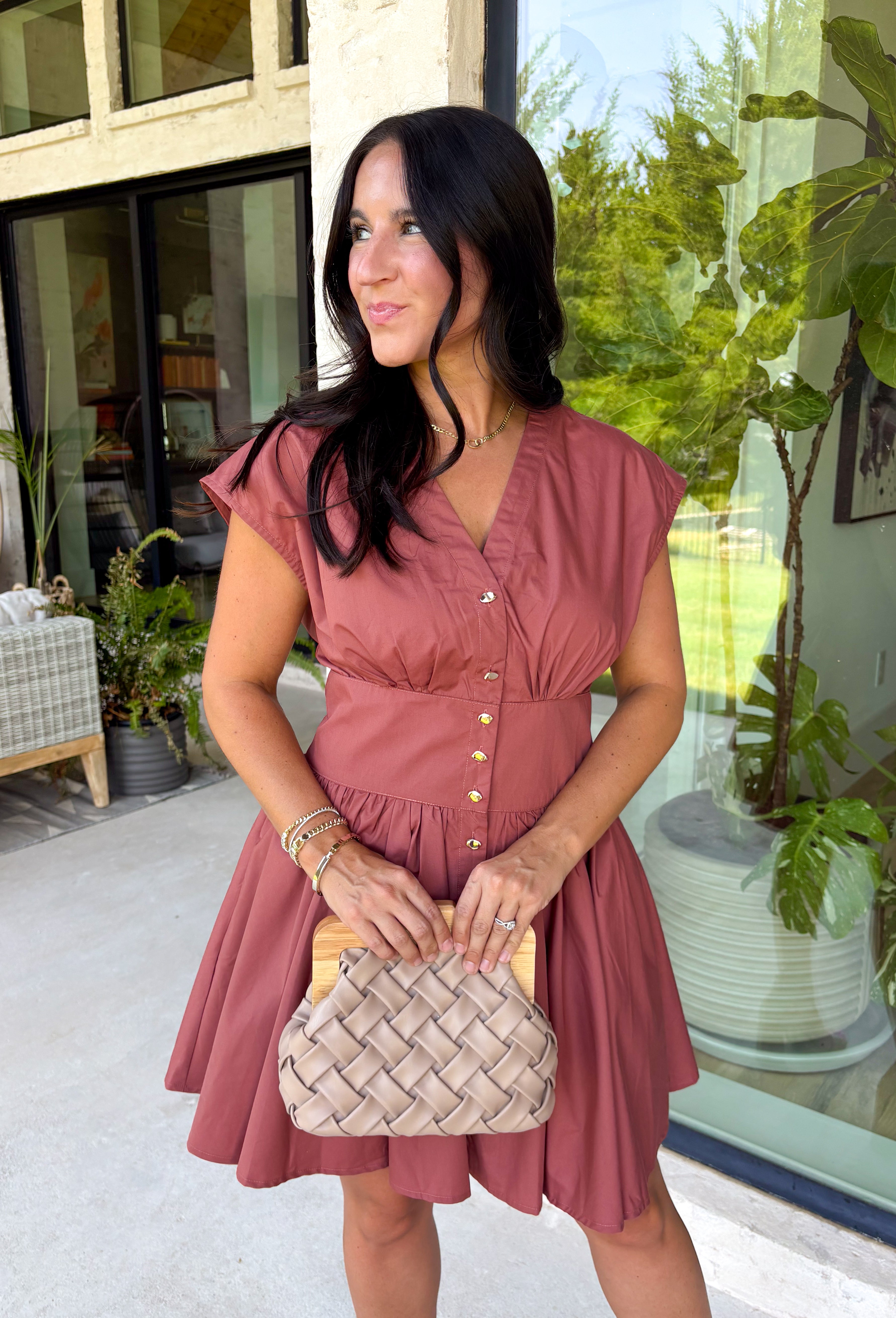 Easy, timeless, and effortlessly flattering, this clay dress is ready for all your favorite fall moments! The warm clay hue pairs beautifully with the season, while the v-neckline and button front create a classic, polished look. Gathered detailing at the waist and a smocked back offer a comfortable, figure-flattering fit you'll love wearing from day to night. 