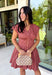 Easy, timeless, and effortlessly flattering, this clay dress is ready for all your favorite fall moments! The warm clay hue pairs beautifully with the season, while the v-neckline and button front create a classic, polished look. Gathered detailing at the waist and a smocked back offer a comfortable, figure-flattering fit you'll love wearing from day to night. 