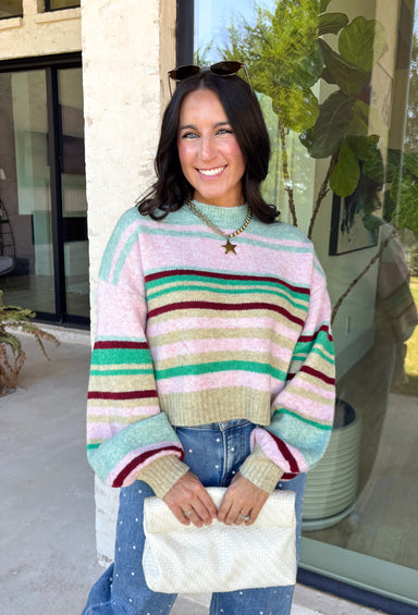 Brighten up chilly days with this irresistibly cozy sweater from Hyfve. Featuring a beautiful stripe pattern in sea foam, light pink, green, tan, and burgundy, this soft knit brings the perfect mix of playful color and timeless fall style. The mock neckline adds a cozy touch for cooler weather, while the ribbed neckline, cuffs, and hem create a polished finish. 