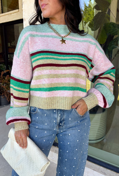 Brighten up chilly days with this irresistibly cozy sweater from Hyfve. Featuring a beautiful stripe pattern in sea foam, light pink, green, tan, and burgundy, this soft knit brings the perfect mix of playful color and timeless fall style. The mock neckline adds a cozy touch for cooler weather, while the ribbed neckline, cuffs, and hem create a polished finish. 