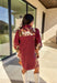 This burgundy button-down dress by Entro is a timeless piece with a fall-ready twist. Featuring a delicate floral print along the sides, it’s designed with a ruffled accent v-neckline for a touch of femininity. The elastic sleeves make for an easy, comfortable fit, while the full lining ensures effortless wear. With its rich color and flattering silhouette, this dress transitions seamlessly from day to night.